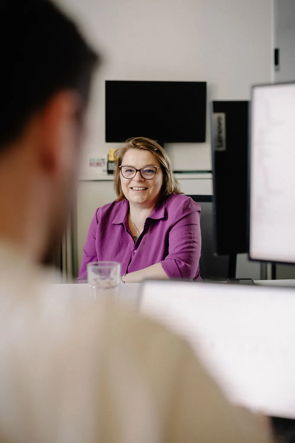 A consultant in a meeting at her desk