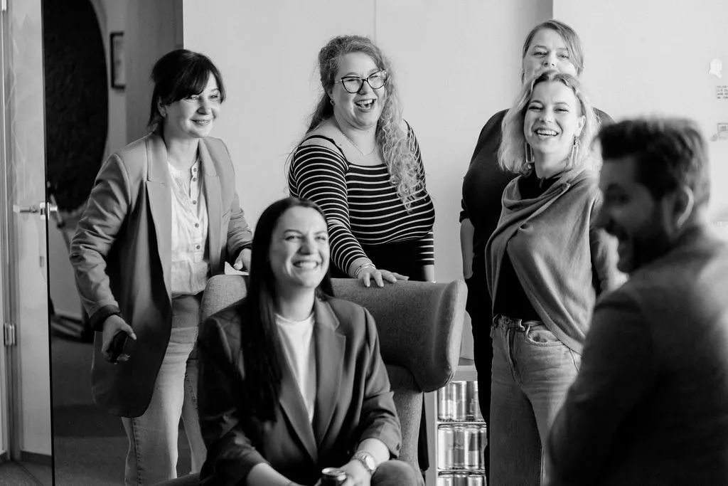 The phaze01 team laughing together in the Bucharest office